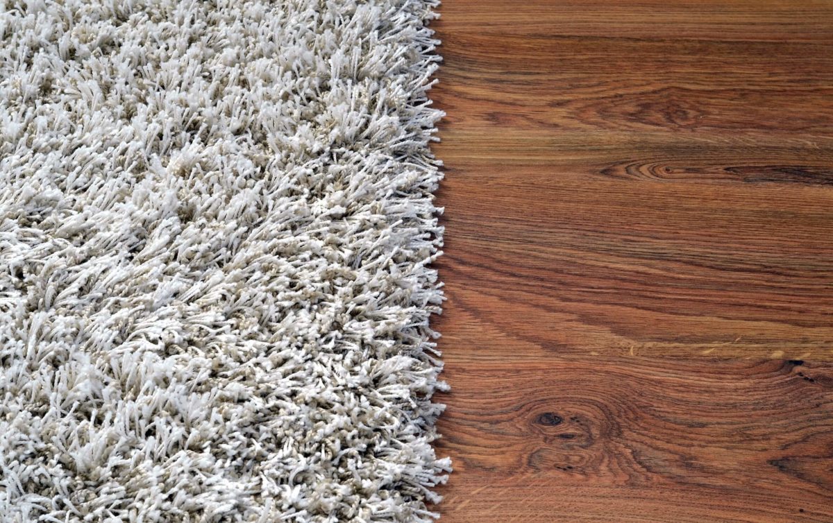 Hard wood flooring and white rug